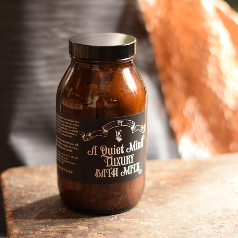 Brown jar labeled 'A Quiet Mind' on a wooden surface with a blurred background