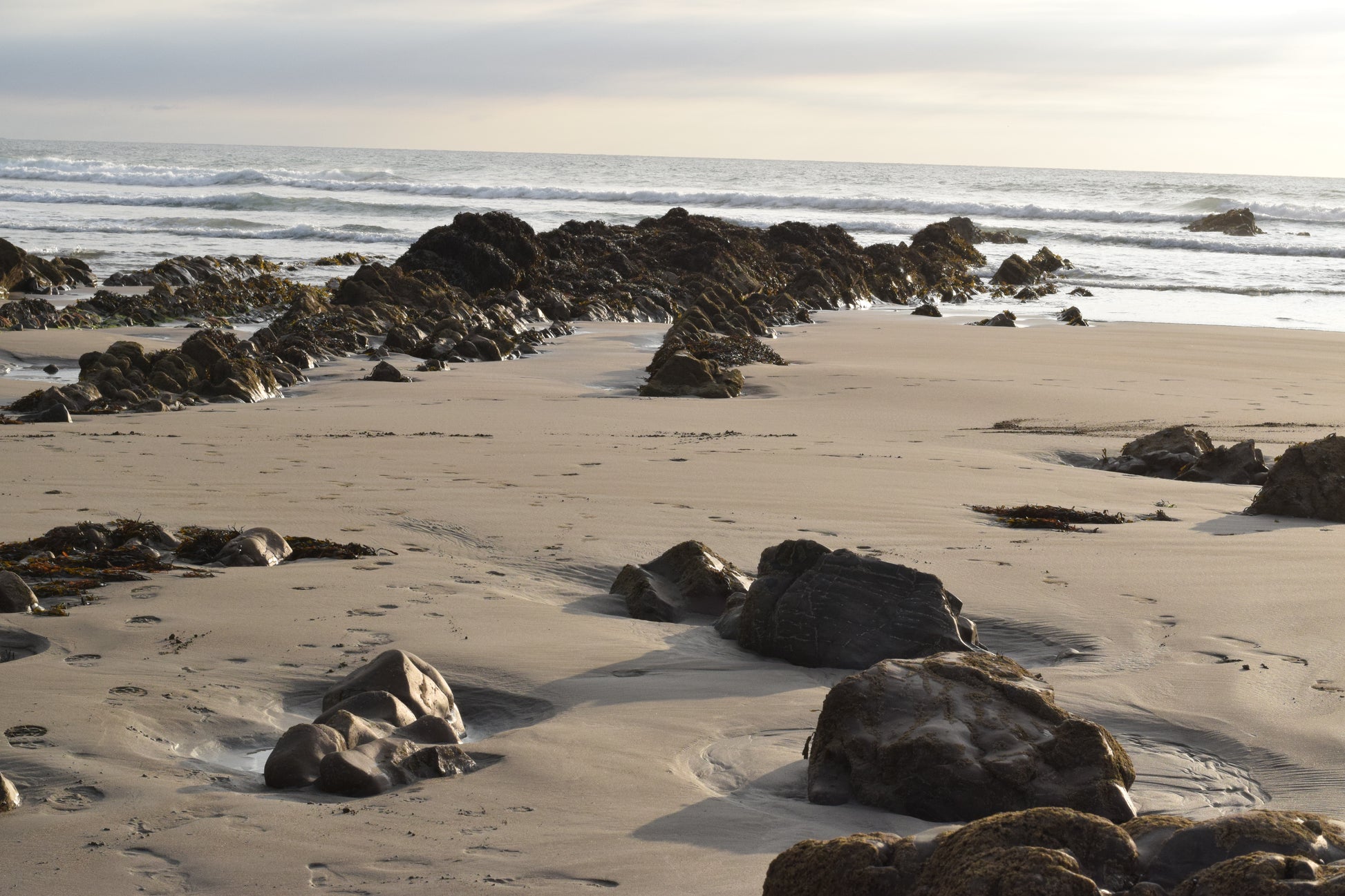 Beach scene with rocks and sand near the water