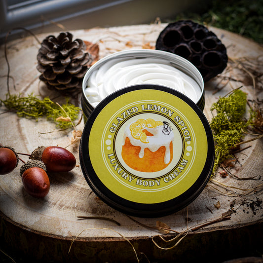 Body cream container labeled 'Glazed Lemon Spice' on a wooden surface with natural elements.