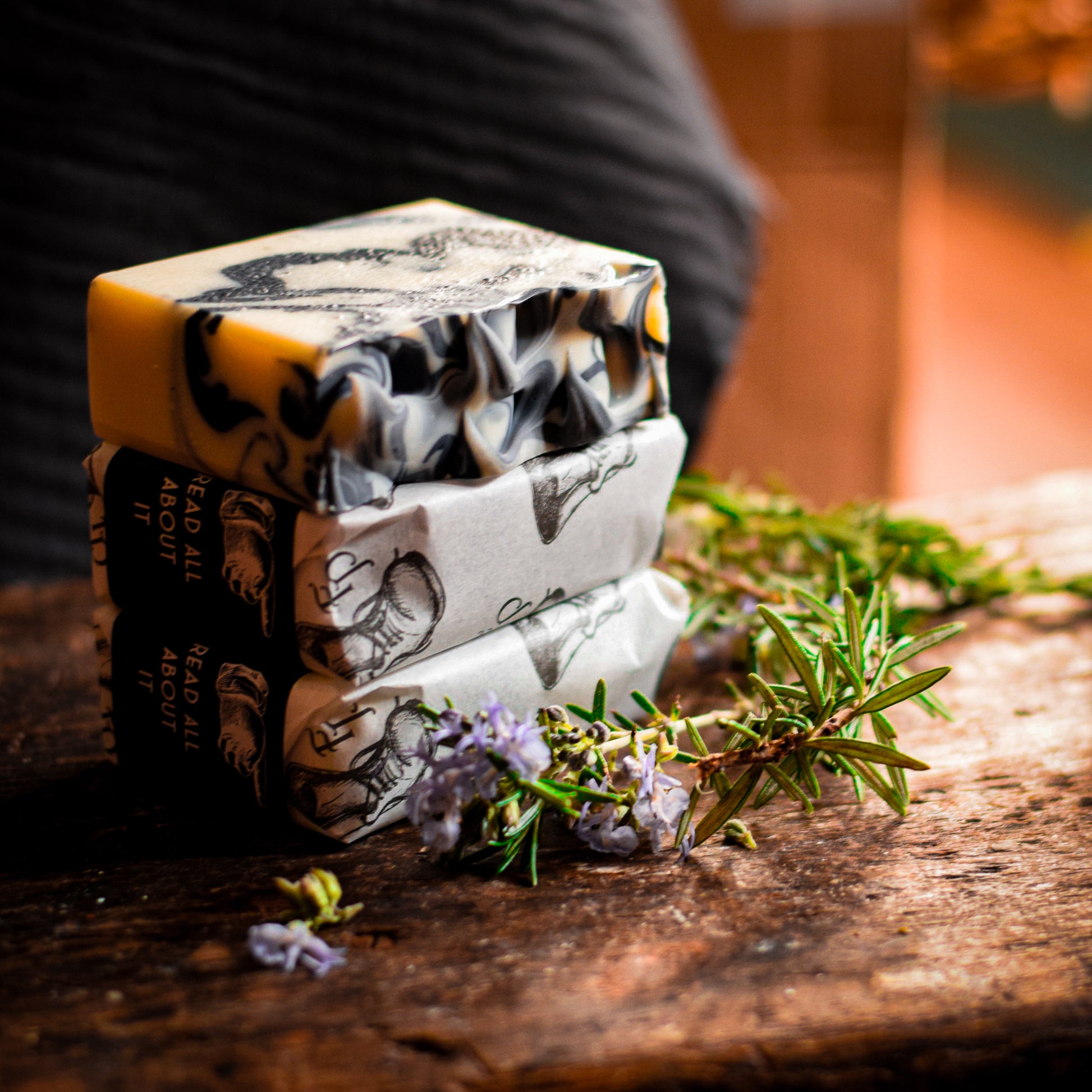 Stack of soap bars with decorative elements on a wooden surface