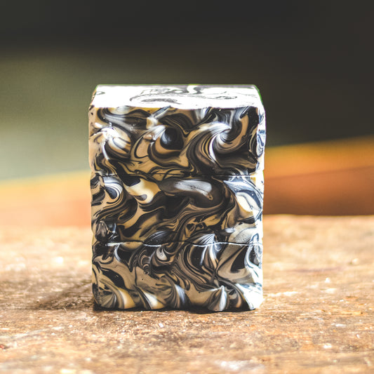 Marbled stack of soap on a wooden surface with a blurred background