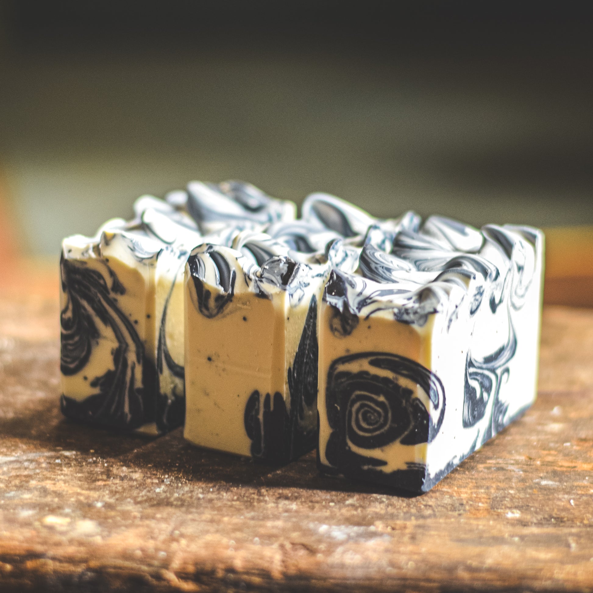 Marbled blue and white soap bars on a wooden surface