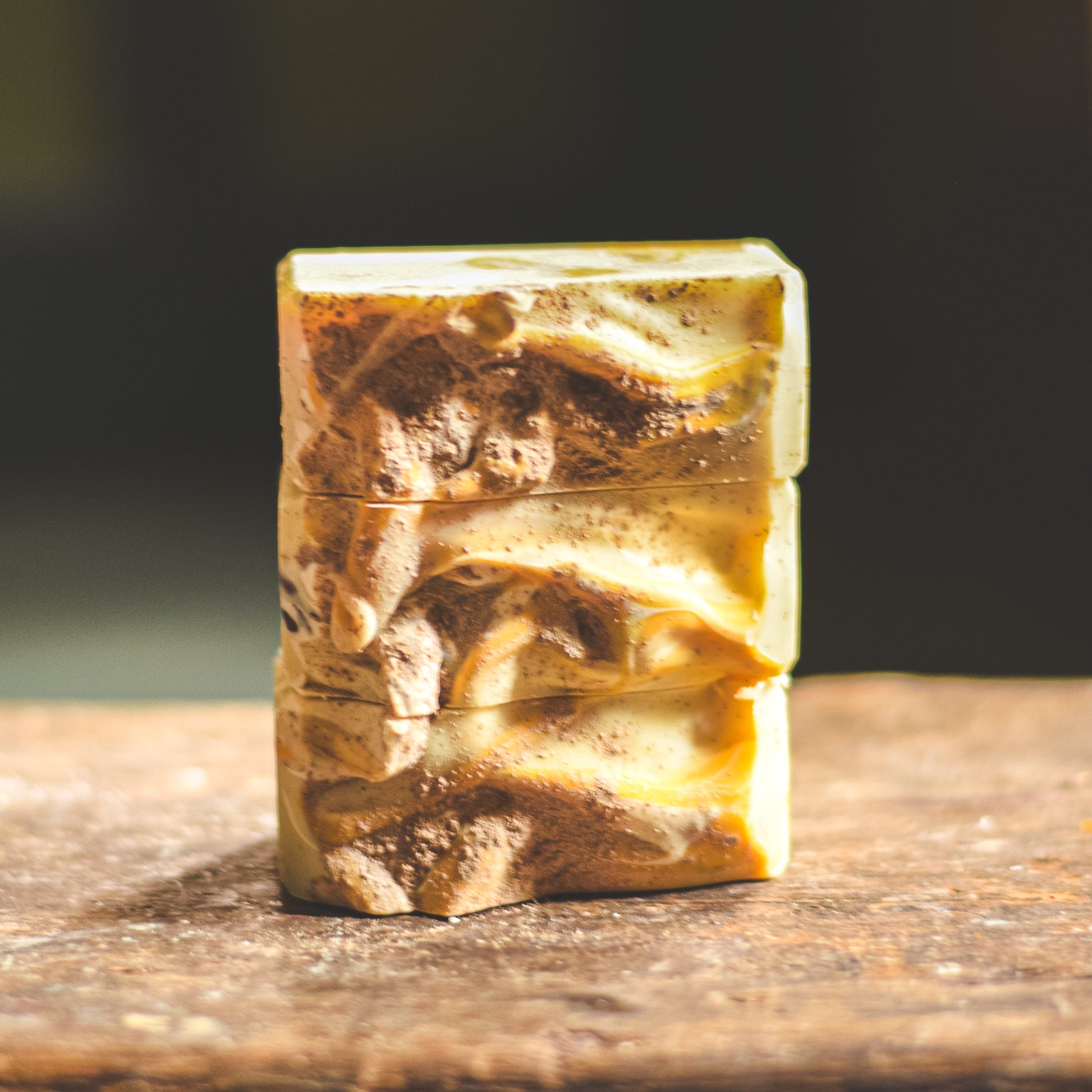 Bar of soap with a wavy texture on a wooden surface