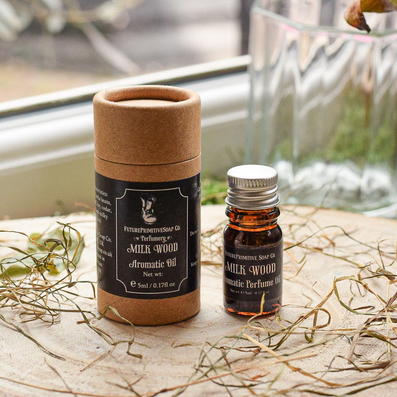 Aromatherapy oil bottle with a cardboard container on a natural surface