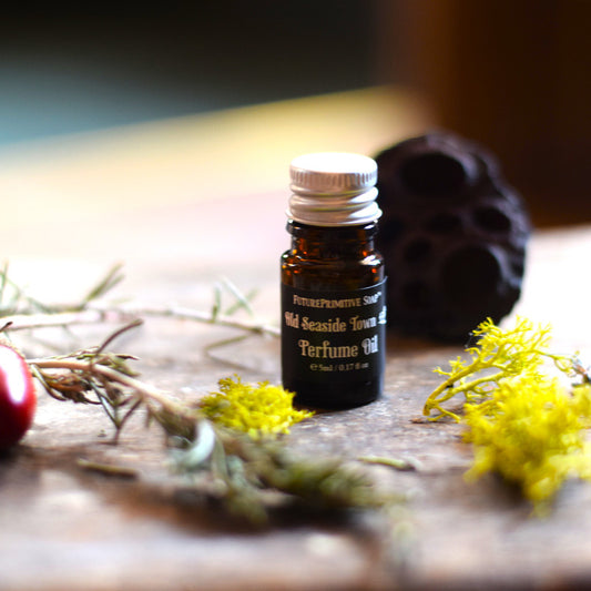 Perfume oil bottle on a wooden surface with natural elements