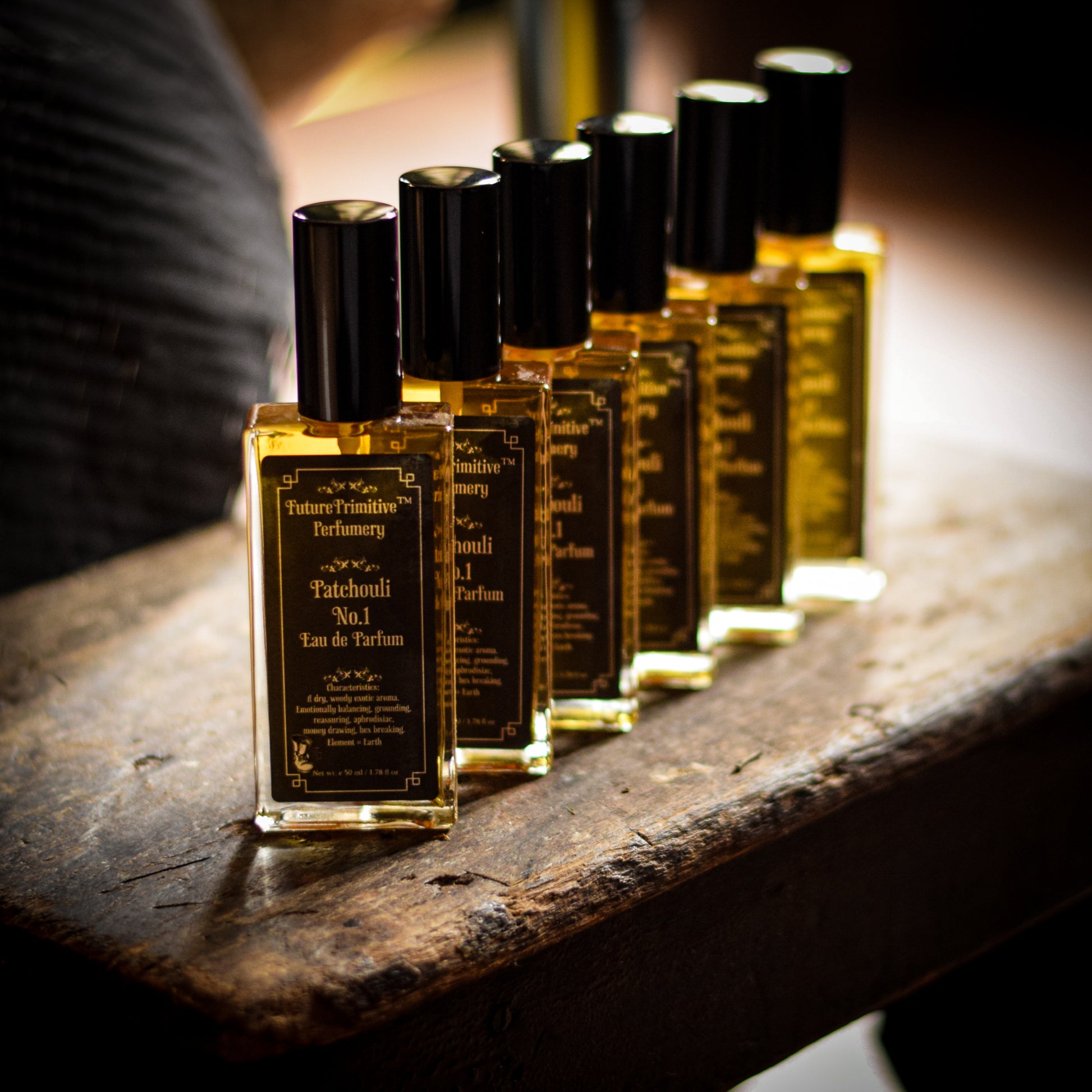 Row of perfume bottles on a wooden surface with a blurred background