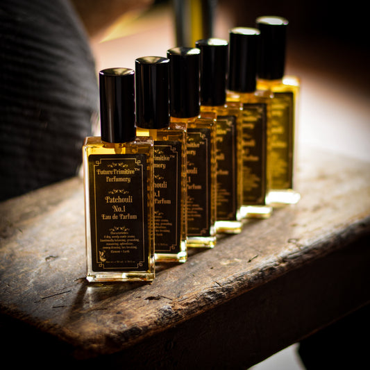 Row of perfume bottles on a wooden surface with a blurred background