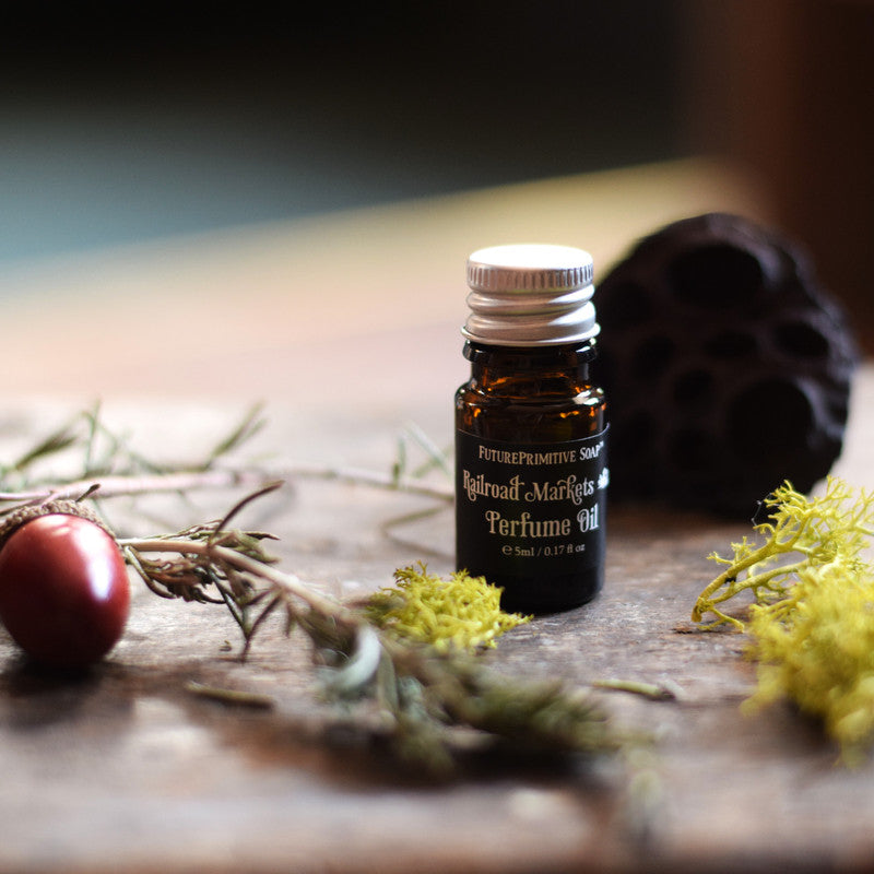 Perfume oil bottle with natural elements on a wooden surface