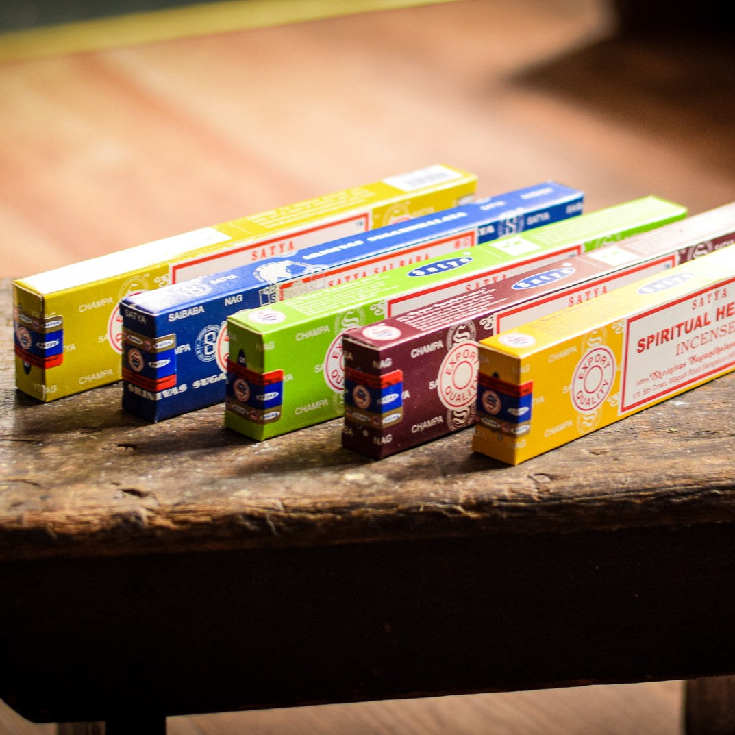 Row of incense boxes on a wooden surface