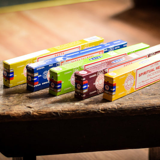 Row of incense boxes on a wooden surface