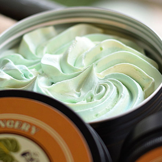Green and white swirled soap in a tin with branding.