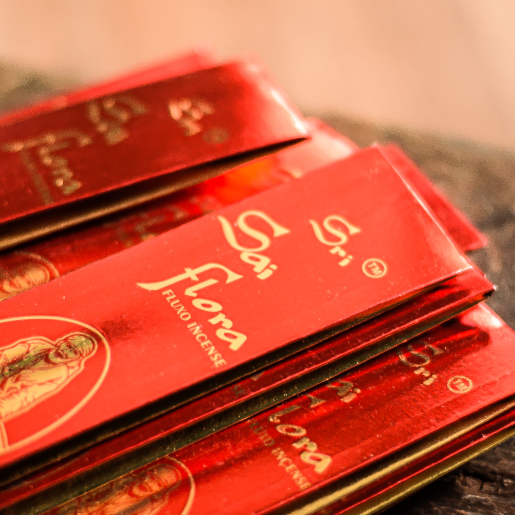 Red packets with Sri Sai Flora branding on a reflective surface
