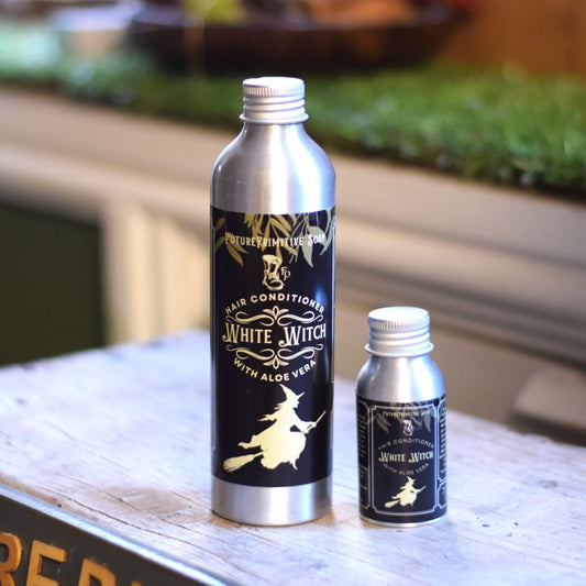 White Witch hair conditioner in two different sized bottles
