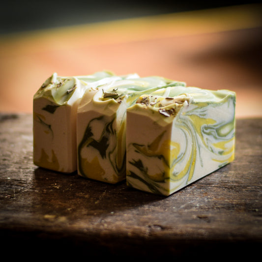 Marbled soap bars on a wooden surface with a blurred background