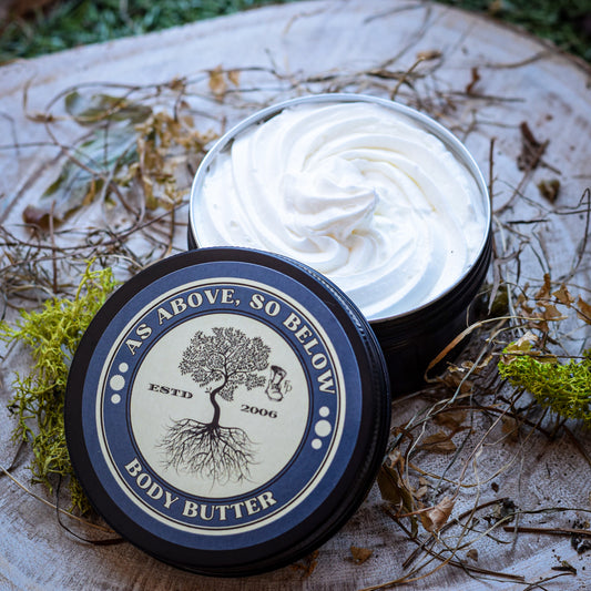 Body butter container with 'As Above, So Below' branding on a natural background