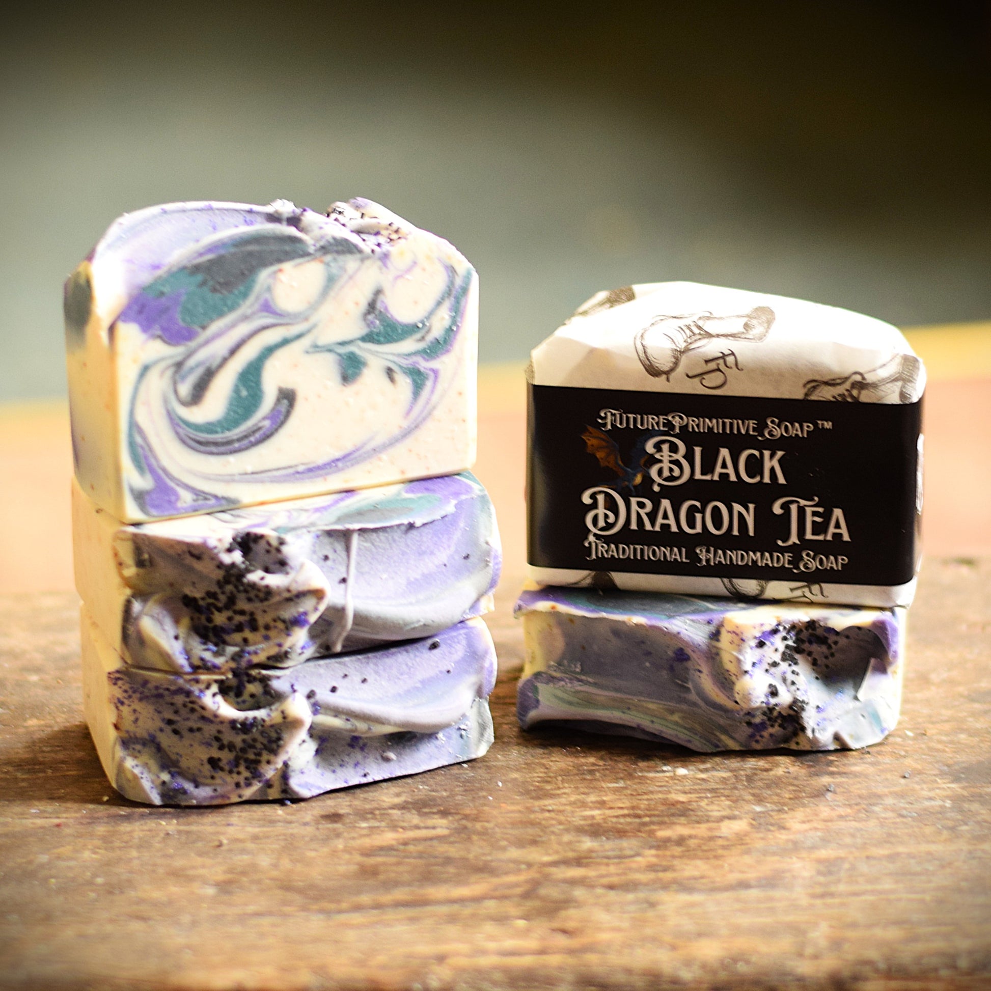 Two bars of soap with marbled designs and a label on a wooden surface