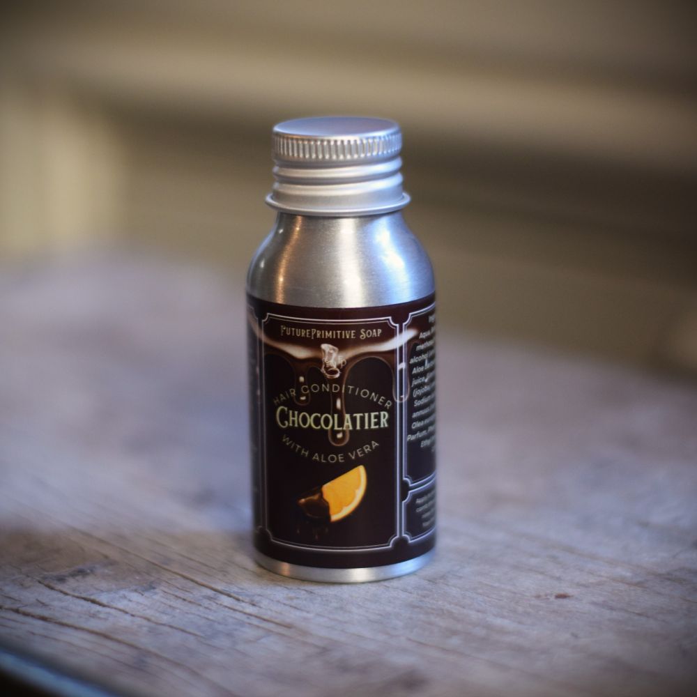 Small metal bottle with a dark label on a wooden surface