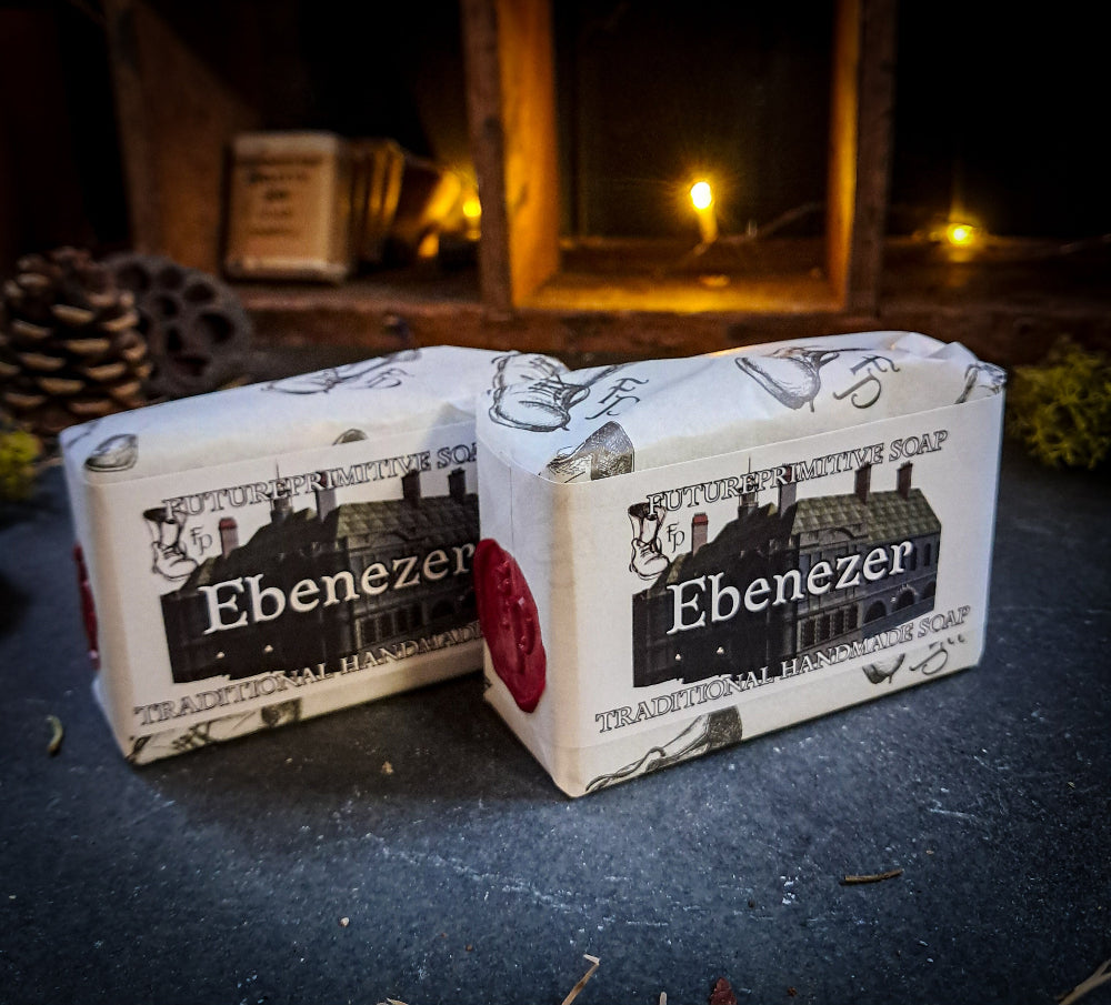 Two bars of soap with 'Ebenezer' branding on a dark surface.