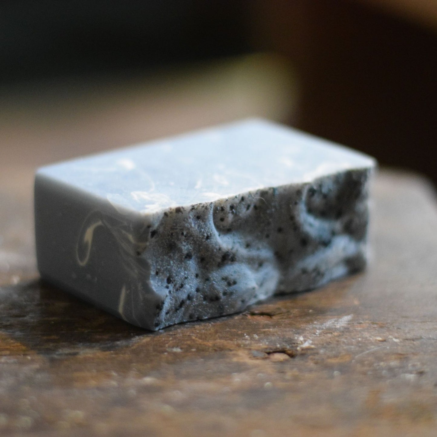 Bar of soap with a textured surface on a wooden surface
