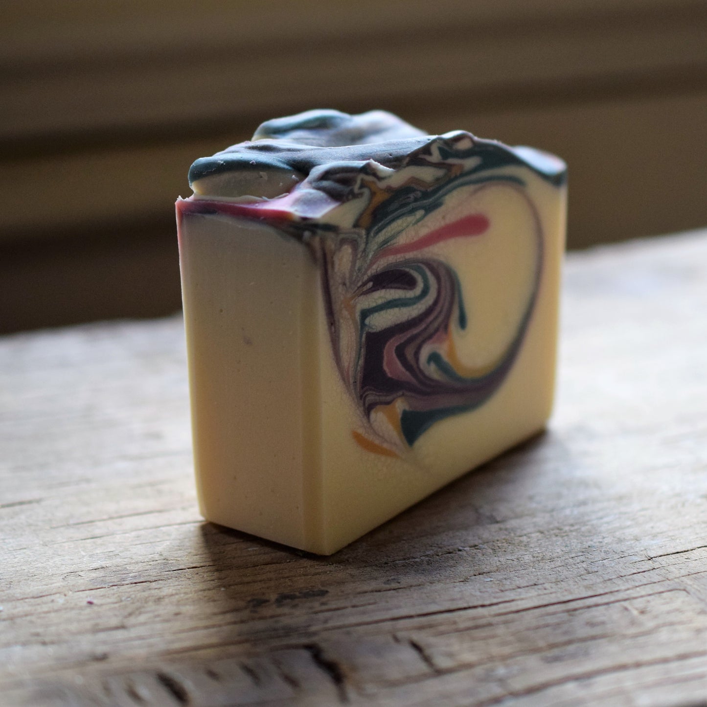 Colorful marbled soap bar on a wooden surface