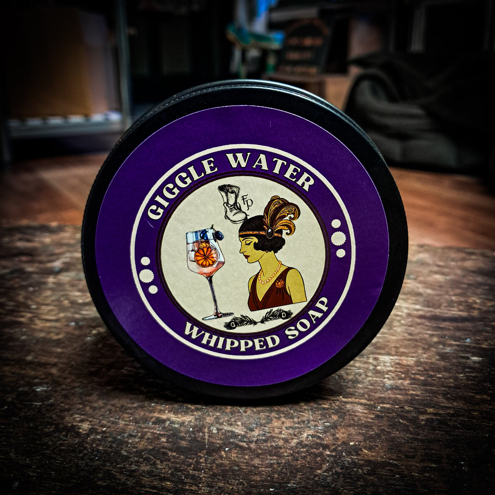Gigglw Water Whipped soap on a dark wood table