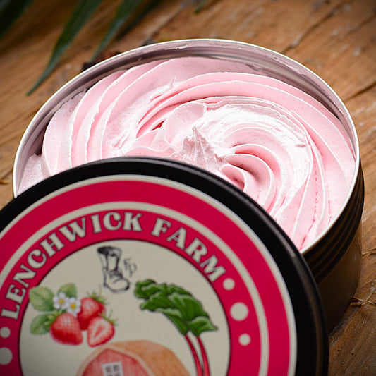 Open container of pink cream with 'Lenchwick Farm' branding on a wooden surface.