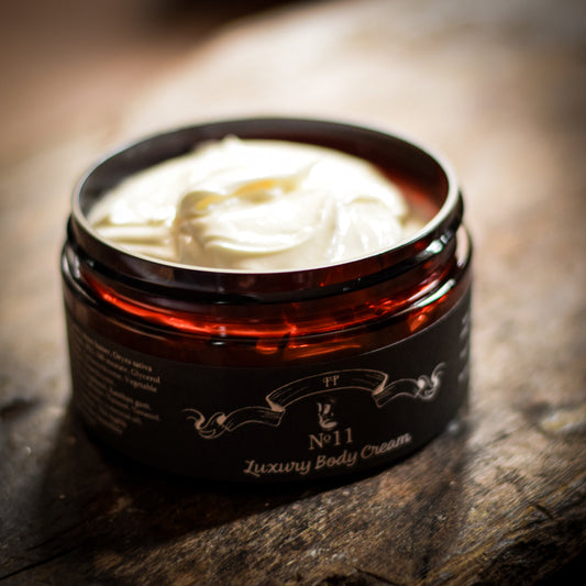 Jar of No.11 luxury body cream on a wooden surface