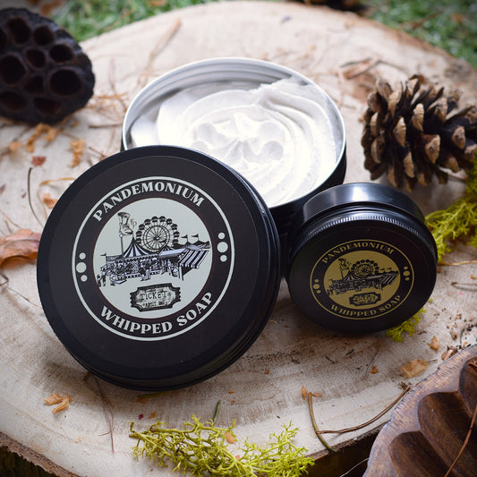 Pandemonium whipped soap sat in natural light surrounded by pine cones