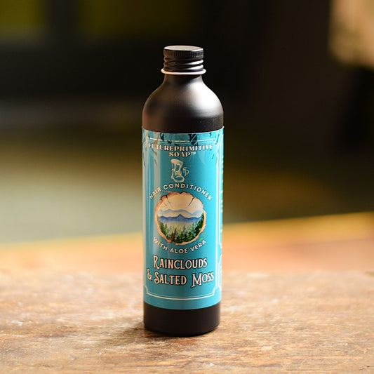 Bottle of hair conditioner with a blue label on a wooden surface
