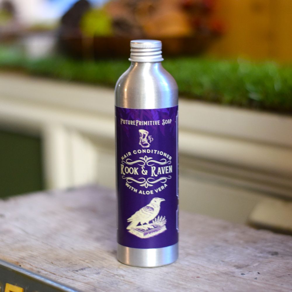 rook & raven hair conditioner in a silver bottle with a purple fancy label