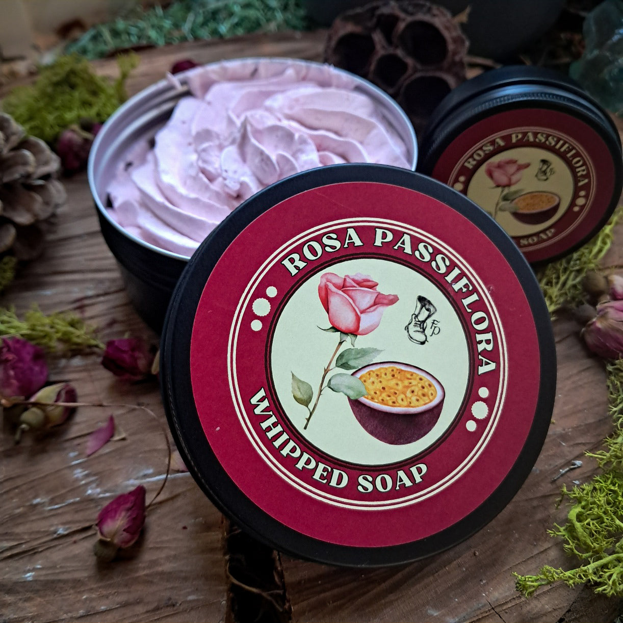 Rosa Passiflora whipped soap with a decorative label on a wooden surface with natural elements.
