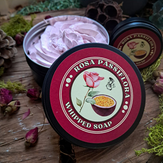 Rosa Passiflora whipped soap with a decorative label on a wooden surface with natural elements.