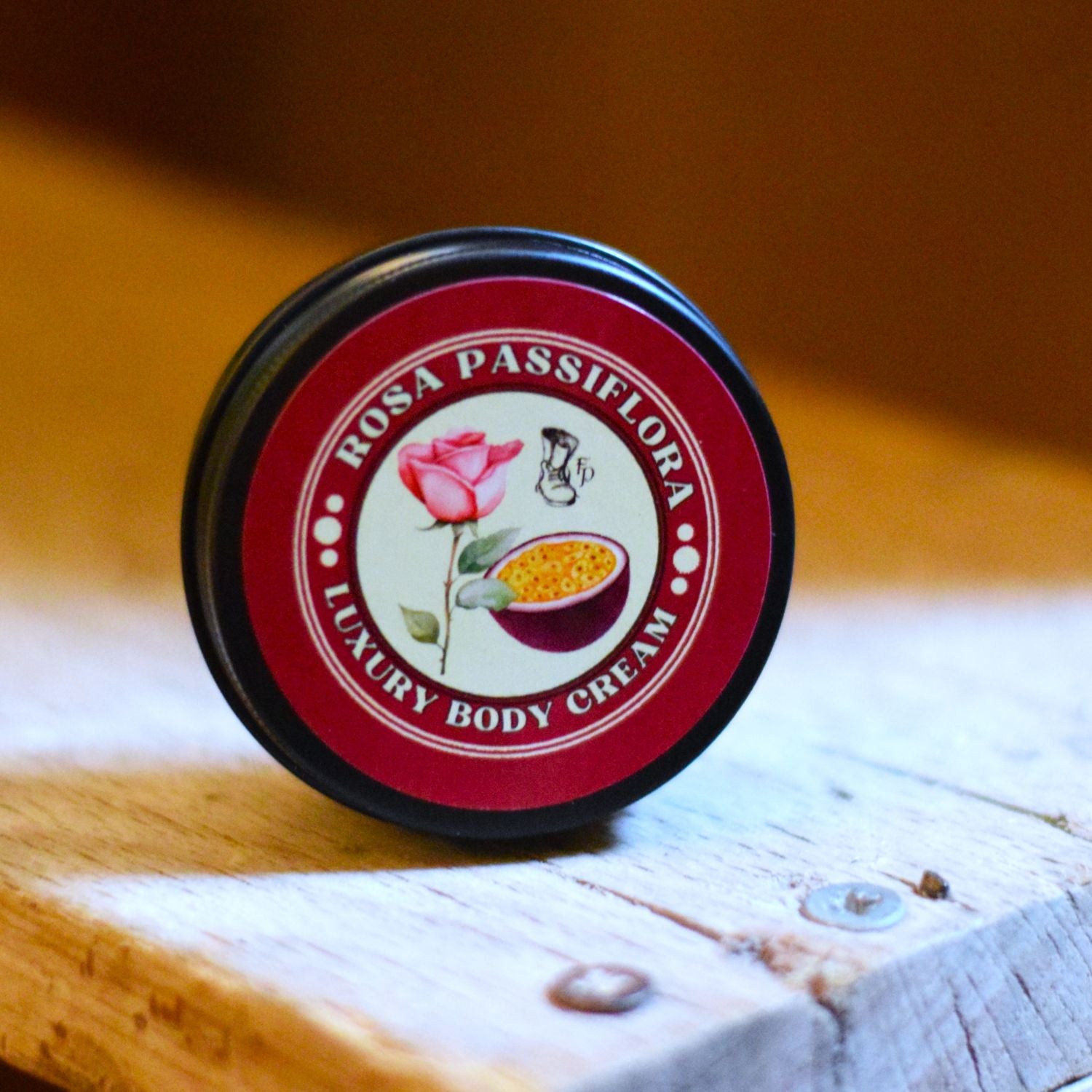 Rosa Passiflora luxury body cream container on a wooden surface