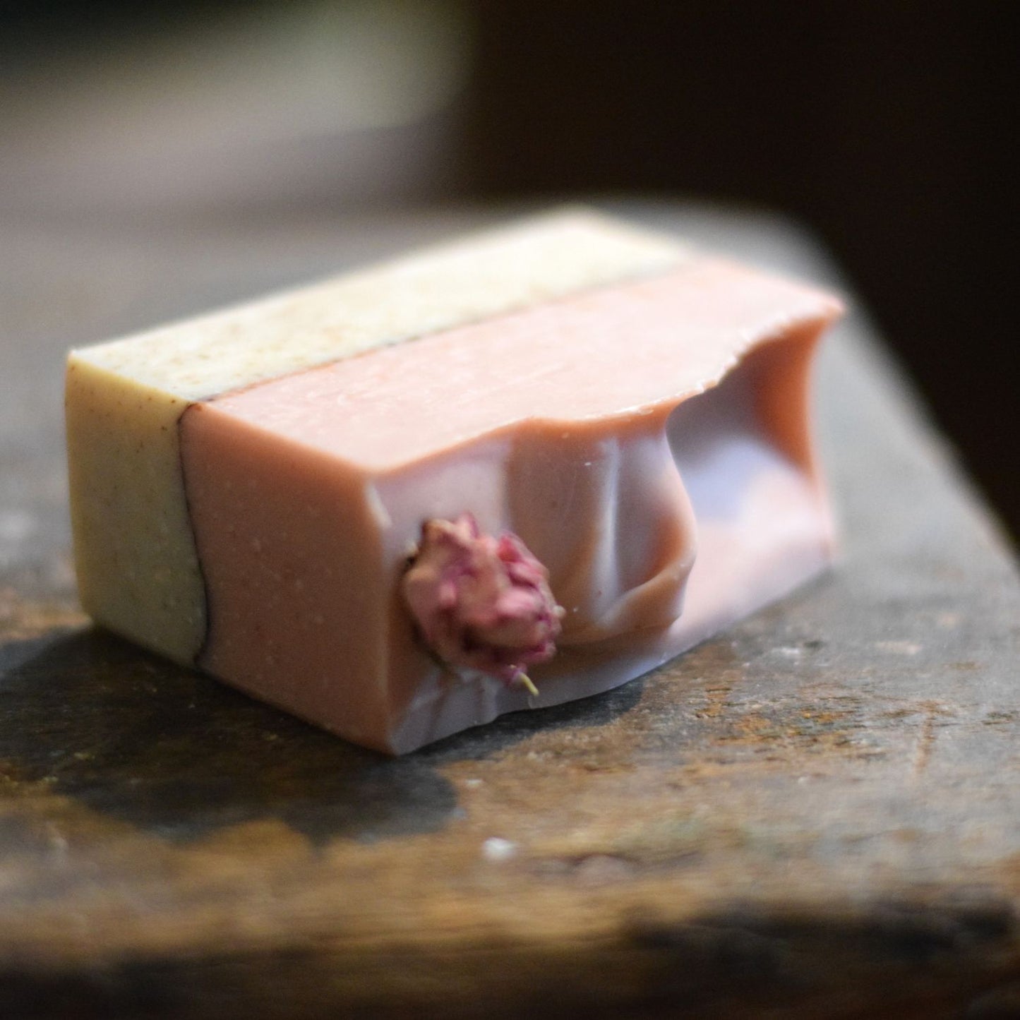 Rose Cardamom soap with a natural design on a wooden surface