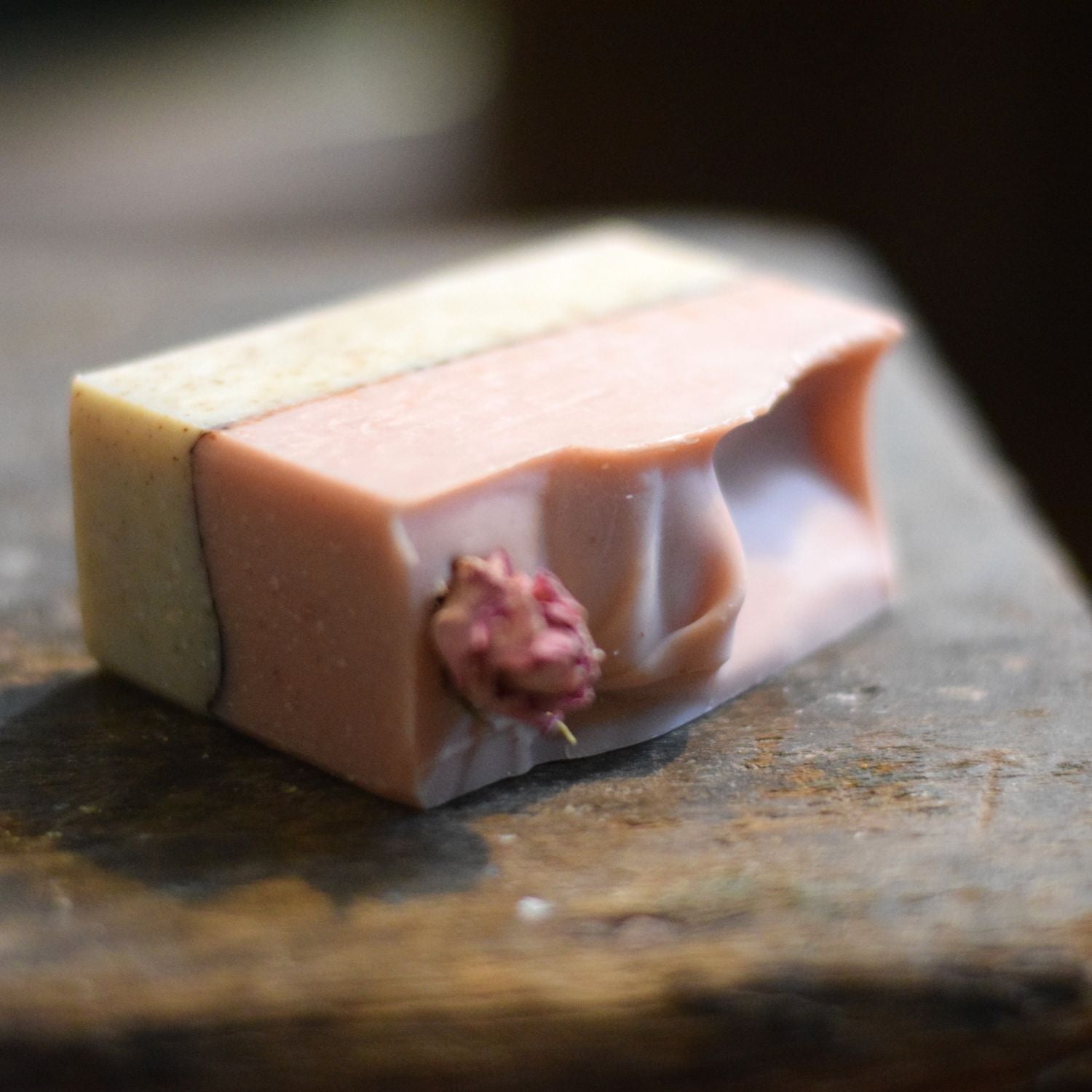 Rose Cardamom soap with a natural design on a wooden surface