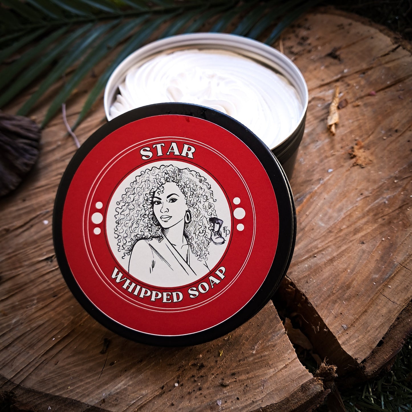 Star Whipped Soap container on a wooden surface with a red label featuring a woman's face.