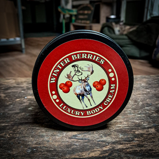 winter berries body cream with a red label sitting on a dark oak table.