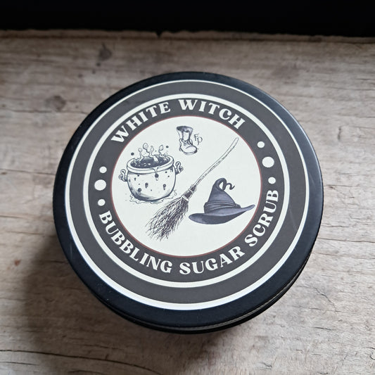 Container lid with 'White Witch' branding and graphics on a wooden surface