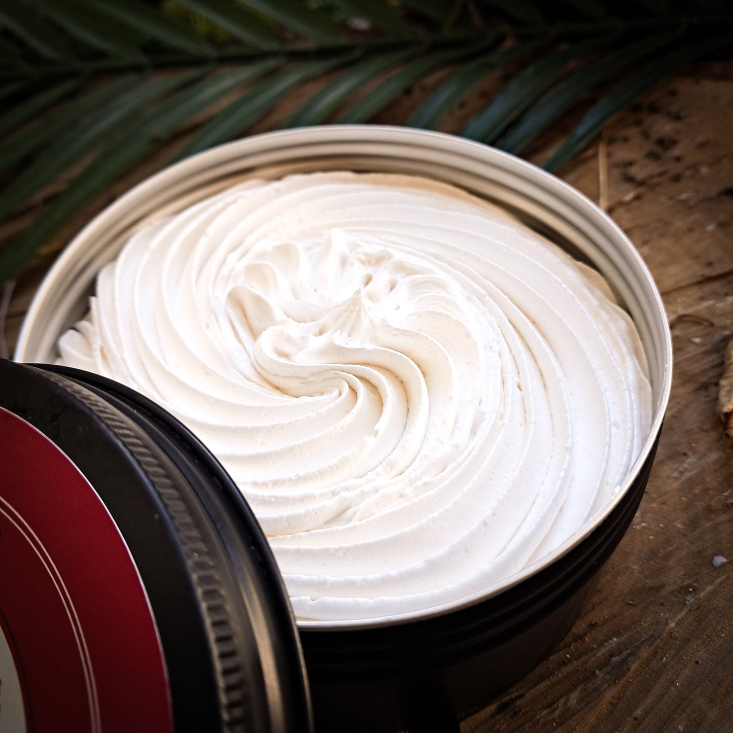 Close-up of whipped soap on a wooden surface.