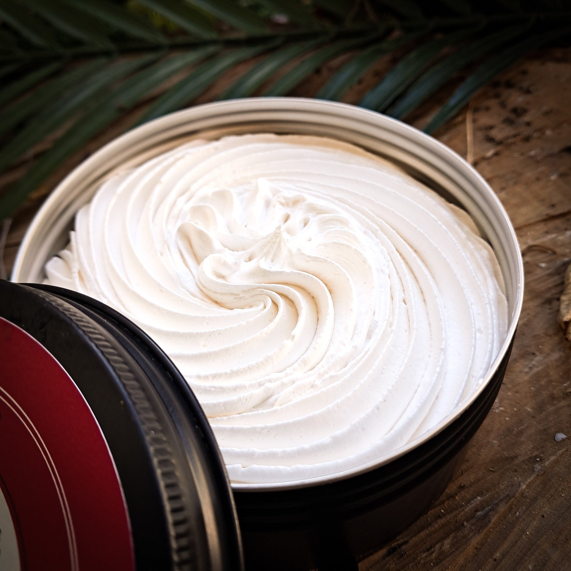 Close-up of whipped soap on a wooden surface.